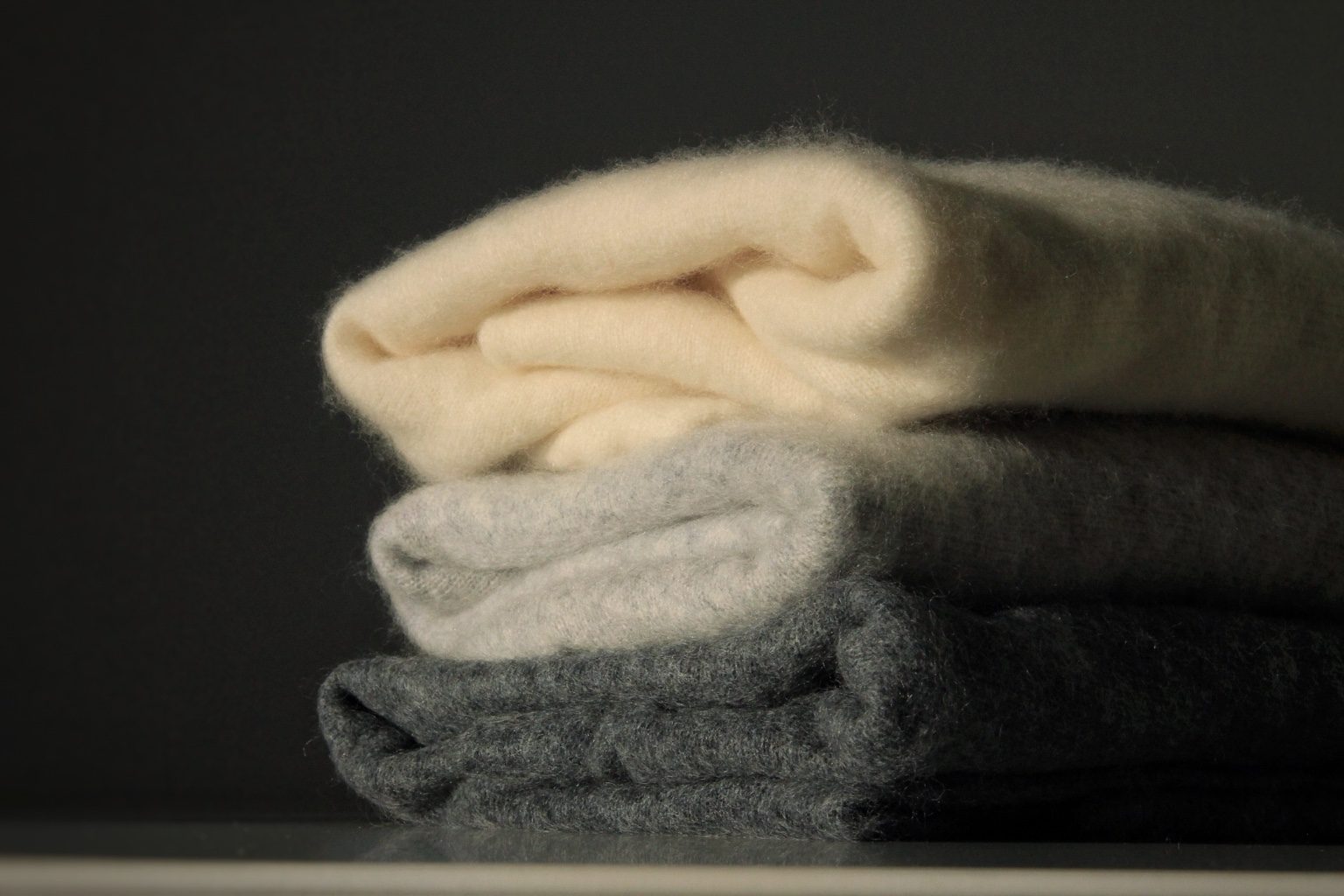 Neutral knitwear styled in a minimal setting